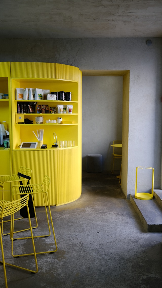 Open shelves against a yellow painted wall