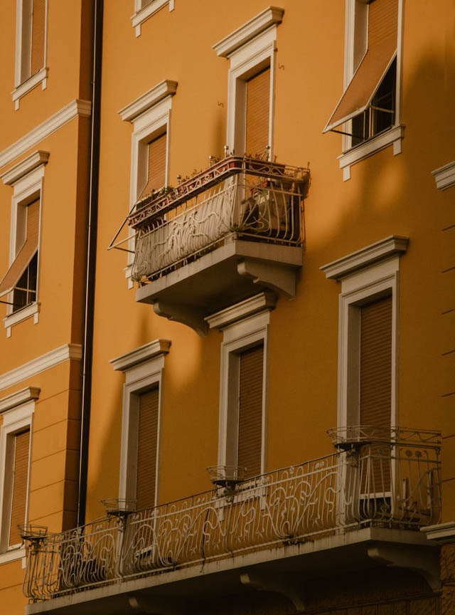 Orange building facade with iron balconies