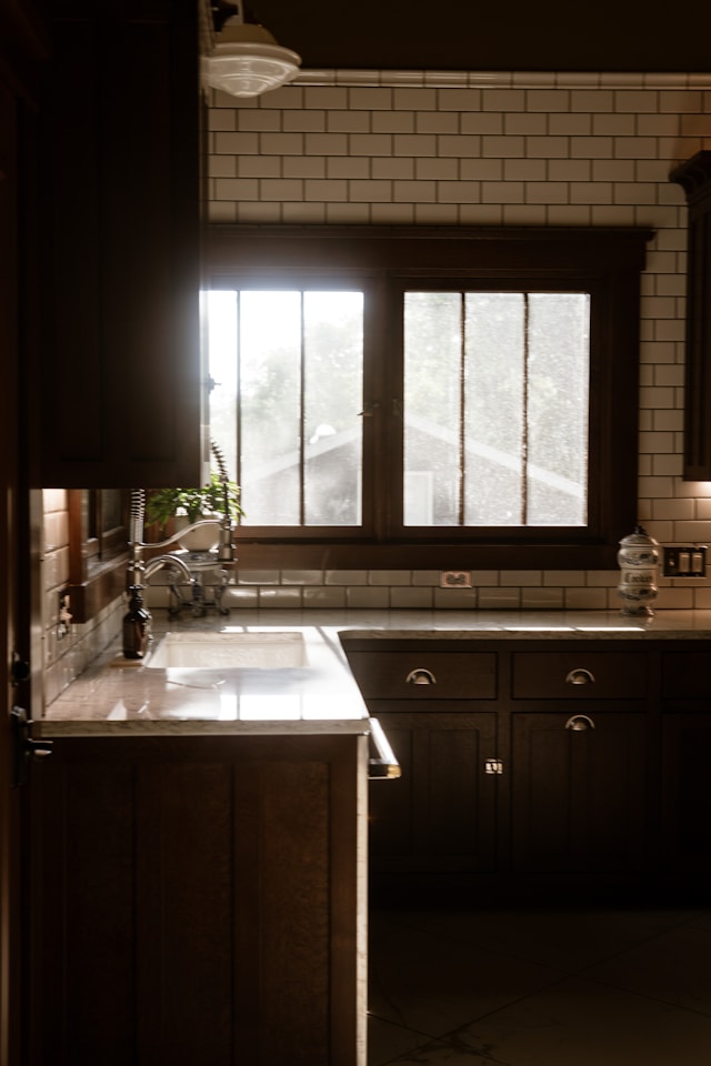 Sunlit kitchen with sink and stove by a window