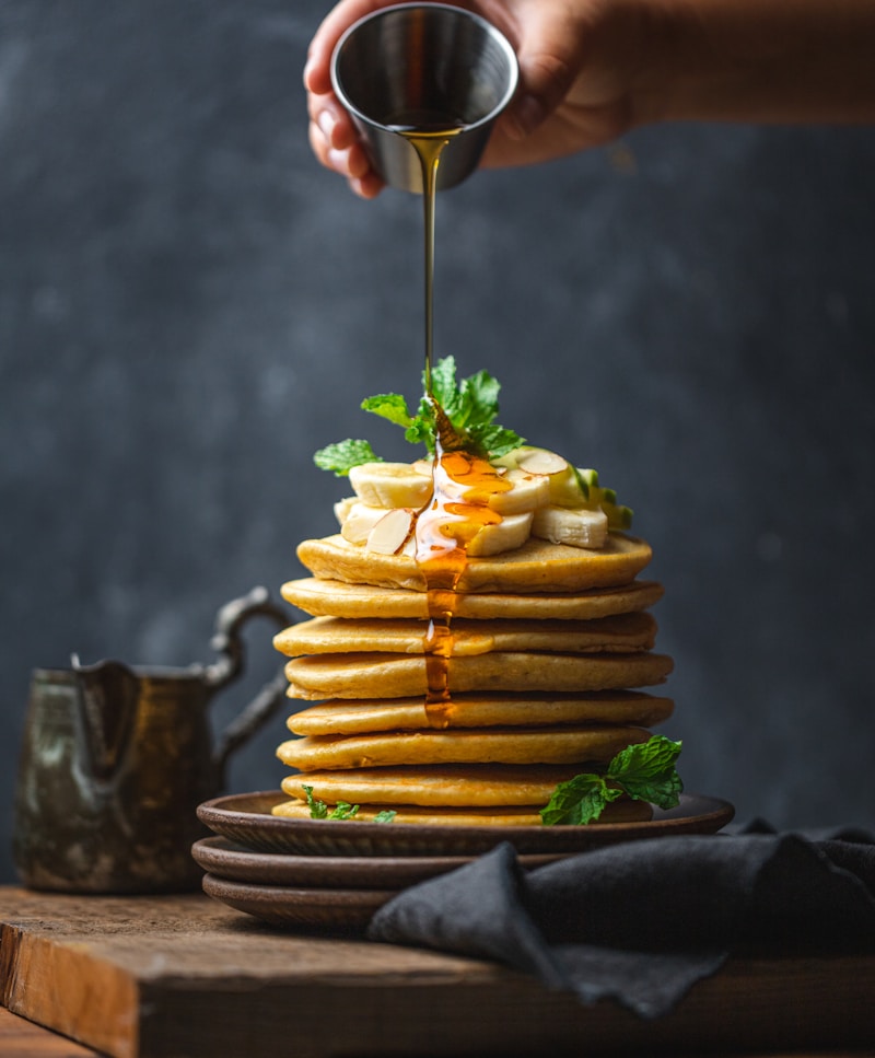 Stack of fluffy pancakes with maple syrup